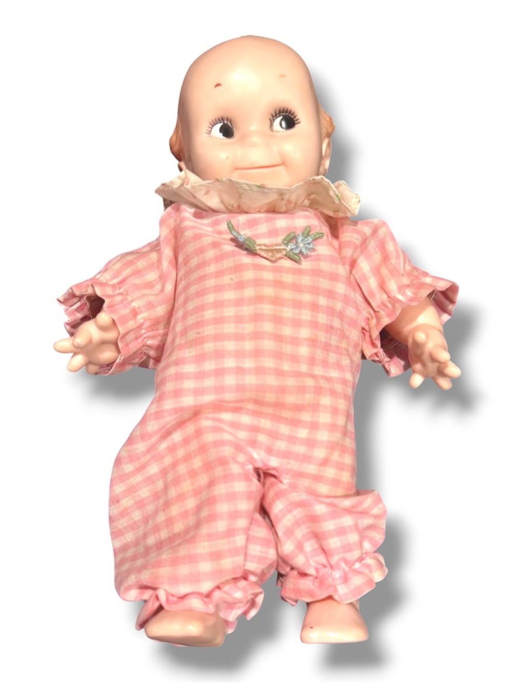 Vintage Kewpie Doll for Collectors, in pink ruffled outfit.